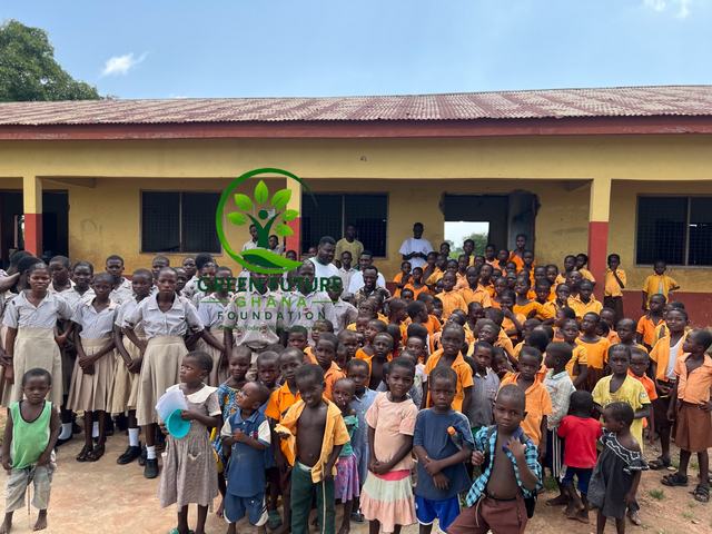 Schoolchildren and teachers gathered in front of their school