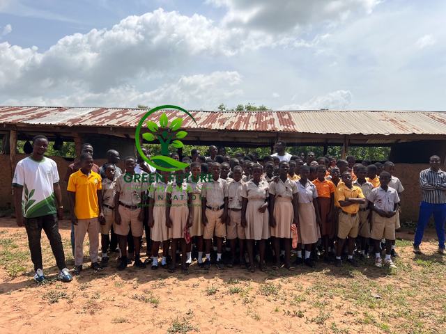 Foundation team members standing with a group of schoolchildren