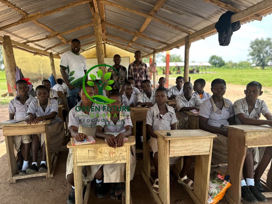 Pupils in school uniform at desks in an open-sided classroom